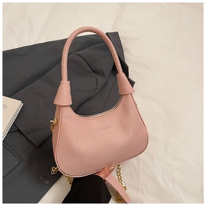 Detail of pink woven texture crescent bag with knot handle and golden chain strap
