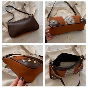 Macro view of vintage patchwork shoulder bag with canvas texture and gold metal buckle