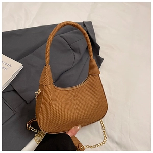 Detail of brown woven hobo bag showing texture, zip closure and gold chain strap