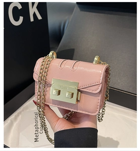 Detail of pink crinkled leather mini crossbody bag with golden chain and clasp