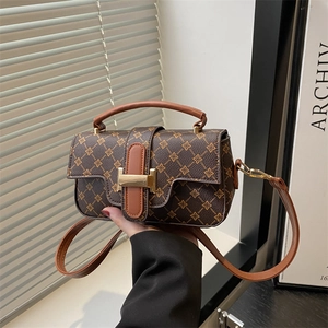 Retro contrast color crossbody bag with classic print and gold H-buckle in lifestyle setting