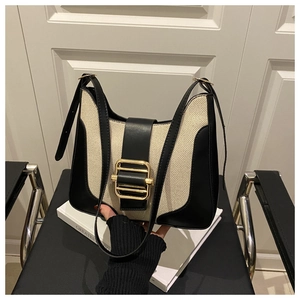 Detail of vintage contrast handbag featuring premium leather stitching and gold buckle