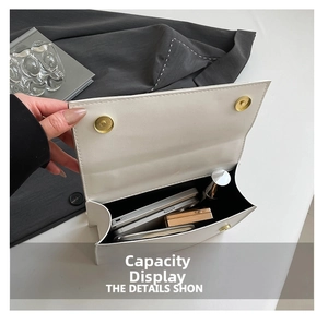 Interior view showing the capacity of a white leather flap bag with magnetic buckles