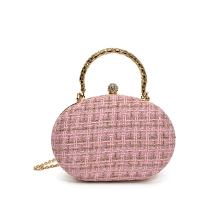 Pink tweed oval evening clutch bag with gold handle and rhinestone lock detail