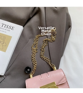 Detail of pink PU leather bag with golden metal lock and elegant chain strap texture