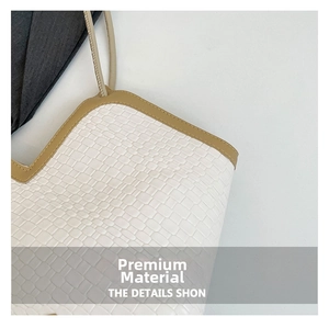 Close-up of cream faux crocodile texture with premium stitching on tote shoulder bag