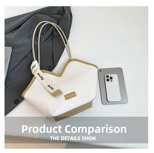 Flat lay of white woven tote bag with khaki trim alongside a blazer and tablet