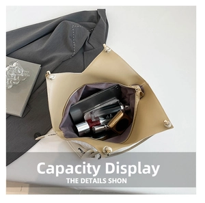 Interior view showing the large capacity of the beige woven tote bag with daily essentials