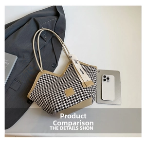 Detail of houndstooth tote bag with beige PU leather handles and decorative ribbon
