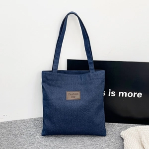 Large capacity navy denim tote bag with brown leather fashion label for casual commuting