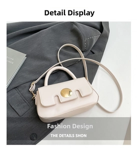 Close-up of cream square bag featuring gold round buckle and stylish U-cut flap detail