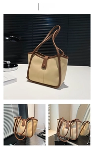 Dettaglio della borsa tote kaki con trama in pelle opaca e spalline sottili