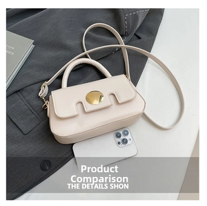 Chic cream leather crossbody bag with gold round buckle shown beside a smartphone for size reference