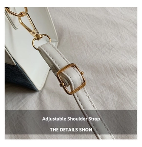 Detail of adjustable white leather shoulder strap with polished gold hardware buckles