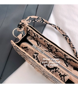 Détail de la bandoulière serpent avec fermeture éclair argentée et sangle nouée