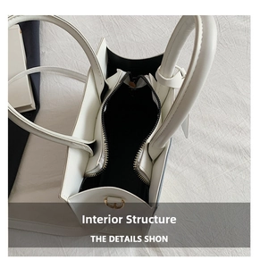 Top view of the white handbag interior showing the black lining and zipper pocket