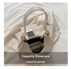 Interior view of beige hobo bag showing capacity for wallet and cosmetics