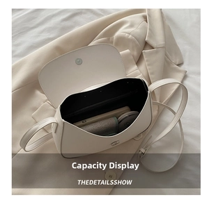 Capacity display of cream white faux leather underarm bag with phone and card holder