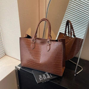 Brown crocodile embossed tote bag with gold hardware and a classic rectangular shape