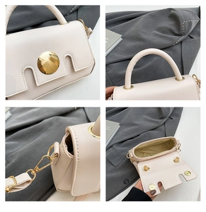 Detail view of cream PU crossbody bag with golden magnetic clasp and cylinder handle