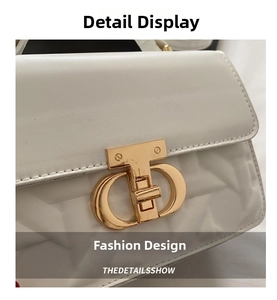 Detailed macro view of white quilted leather texture and gold metal interlocking clasp