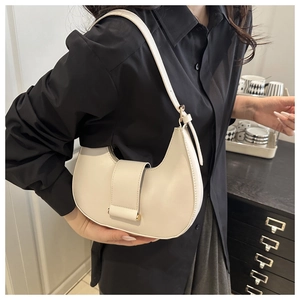Detail of off-white crescent underarm bag with gold hardware and smooth leather texture