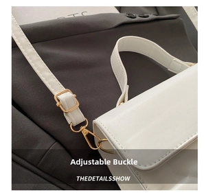 Detail view of the white PU bag with an adjustable golden metal buckle on the shoulder strap