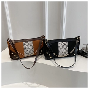 Detail view of contrast stitching shoulder bags with geometric tape and gold rivets