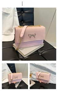Pink PU leather crossbody bag with golden bow buckle and metallic chain strap detail