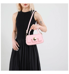 Pink mini crossbody bag featuring geometric cut flap and gold circular metal lock detail
