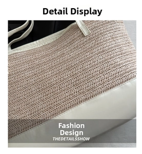 Close-up of woven straw handbag with white leather trim and refined herringbone texture