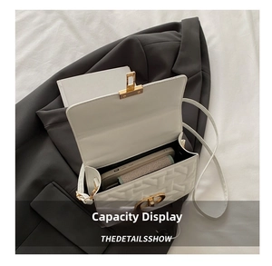 Internal storage capacity of white quilted shoulder bag with metal CD clasp