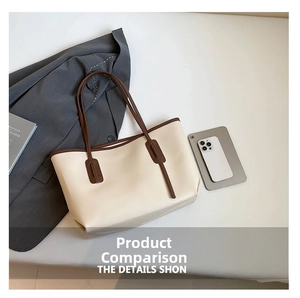 Flat lay of off-white tote bag with brown straps and office items on neutral background