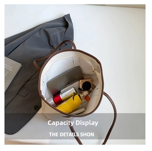 Spacious interior of off-white tote bag showing laptop and daily essentials storage