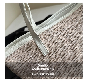 Close-up of beige woven tote bag showing fine stitching and leather trim details