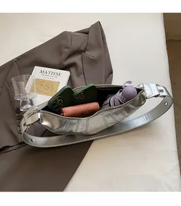 Spacious interior of silver crescent bag showing capacity for phone, wallet and umbrella