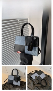 Macro view of blue and black patchwork leather handbag with Fashion Bags tag detail