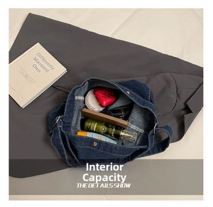Detailed interior of dark blue denim crossbody bag showing spacious main compartment