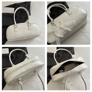 Detailed interior of a white leather pillow bag with pearl chain and lace bow decor