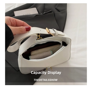 Interior view showing the storage capacity of the white minimalist leather shoulder bag