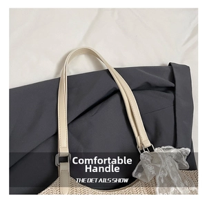 Close-up of straw beach tote with leather handle and white lace bow decoration