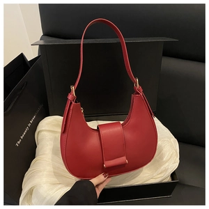 Red crescent shoulder bag with matte leather and buckle detail in a premium gift box