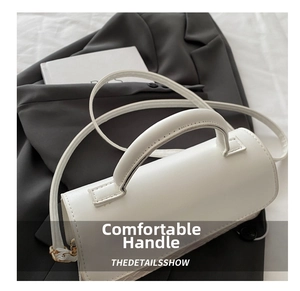 Close-up of white woven embossed texture and curved handle on a minimalist handbag