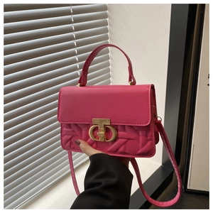Close-up of rose pink crossbody bag featuring woven texture and gold metal buckle