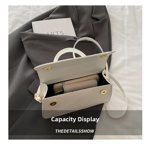 Detailed interior view of white woven crossbody bag showing capacity for phone and items