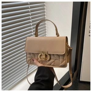 Detail of khaki crossbody bag with quilted texture and golden metal twist-lock