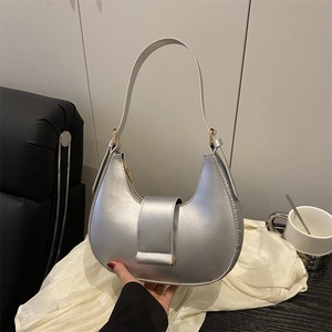 Chic silver hobo handbag with metallic finish and magnetic flap on white silk