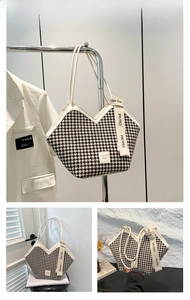 Detail of white houndstooth tote bag with fashion ribbon and v-shaped opening