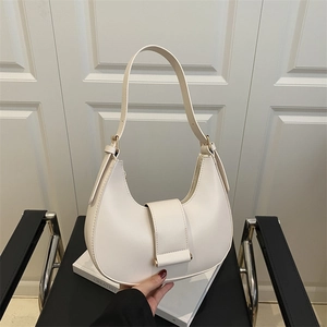 Minimalist cream white hobo underarm bag in smooth faux leather with golden metal buckles
