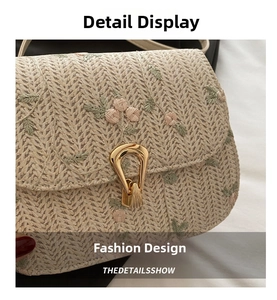 Detail of woven beige saddle bag with pink floral embroidery and gold metal clasp